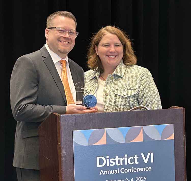 Chris Knudson receiving the Distinguished Service Award from the Council for Advancement & Support of Education District VI