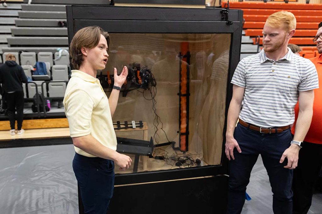 Two male students present their project at RICE Day 2024