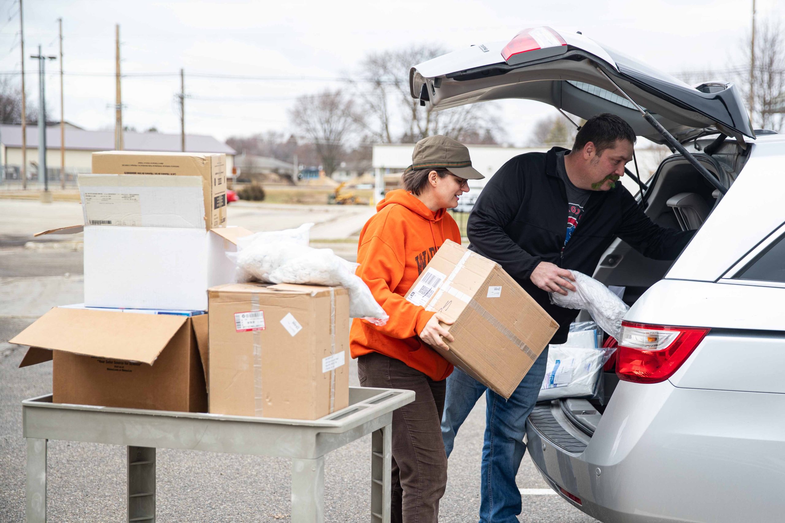 Christine DeVries and Eric Berns load unused personal protective equipment to be donated to the Waverly Health Center as they prepare for a surge in patients with COVID-19.