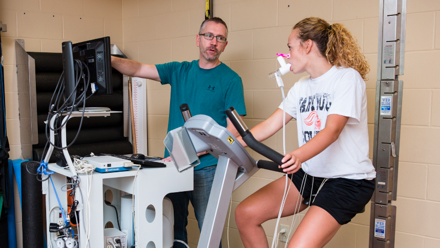 Dr. Ed Westen, Wartburg’s new director of the Department of Health and Physical Education, monitors the cardiopulmonary functions of Emma Gerdes, a sophomore from Cedar Falls, during an exercising stress test.