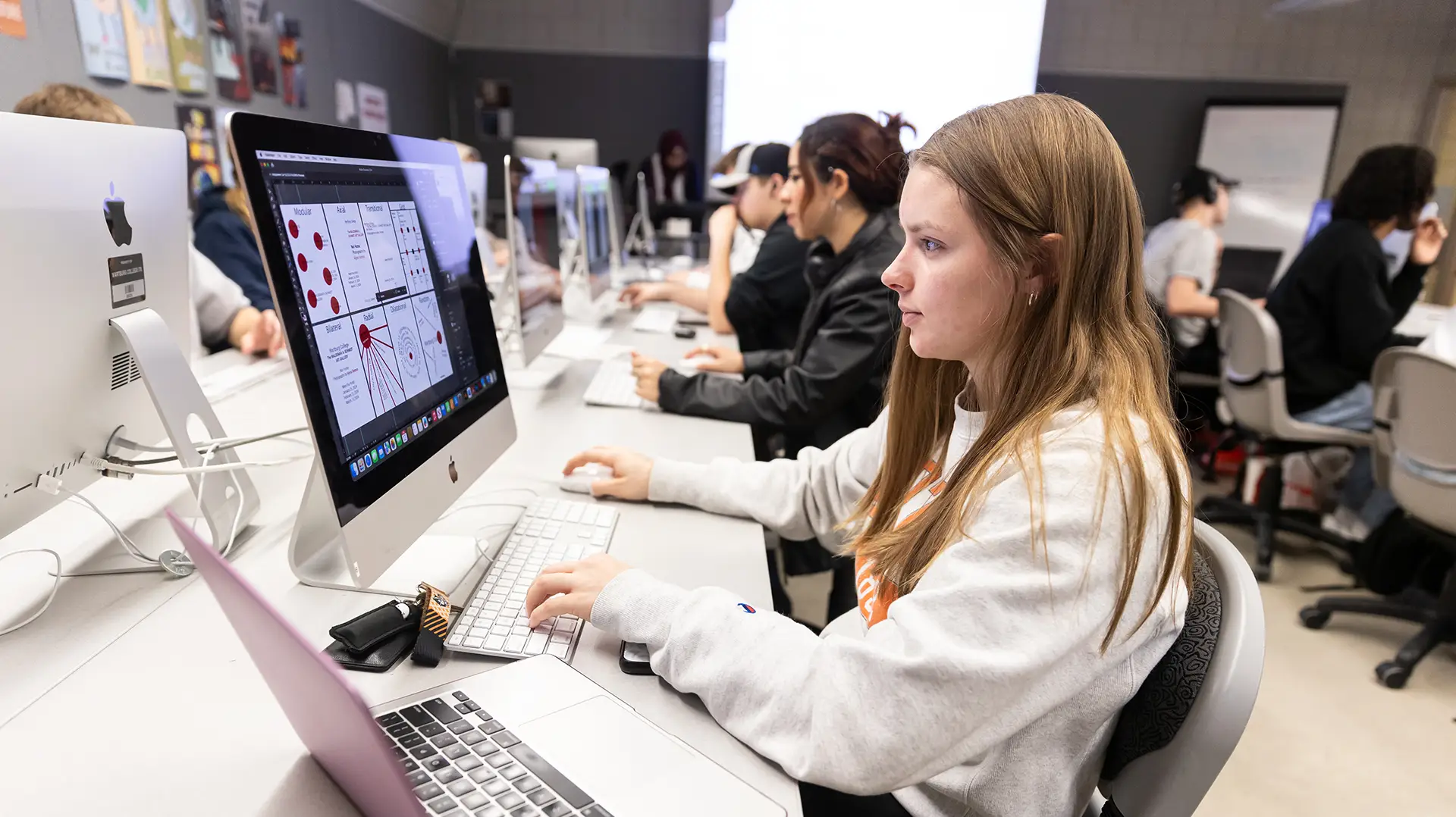 Graphic design student working on a class project in the graphics lab