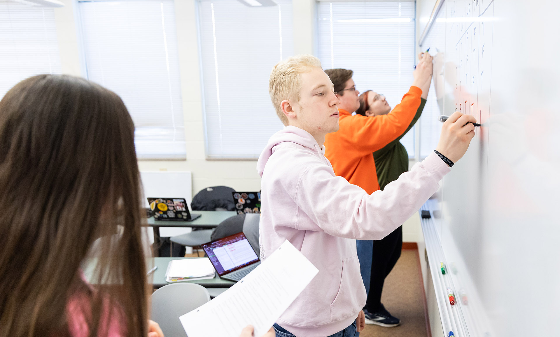 Foundations of Analysis students solving problems on a board