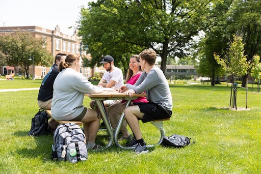 Students sitting at a picnic table