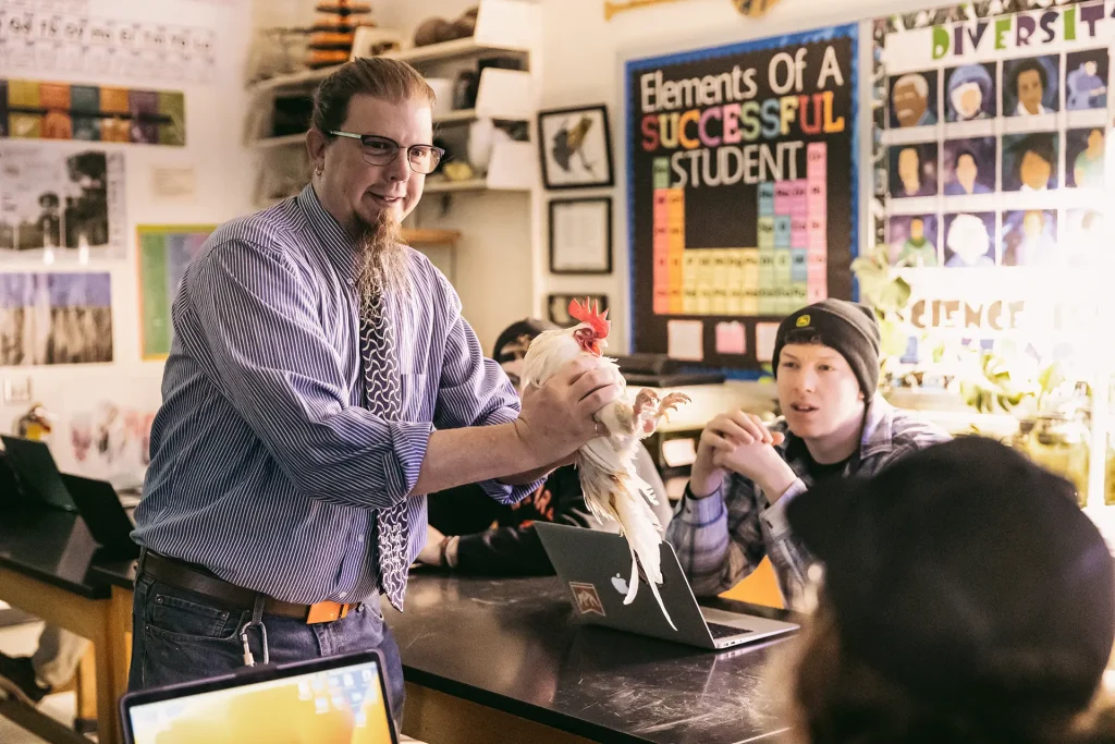 Biology professor showing the class a chicken during a Biology of Ordinary Things class