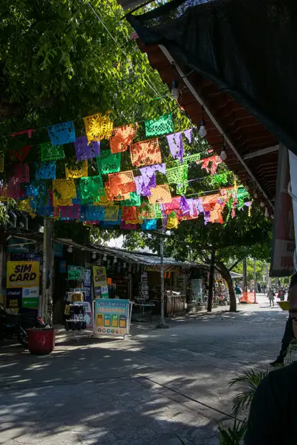 Colorful flags hang over a street in costa rica