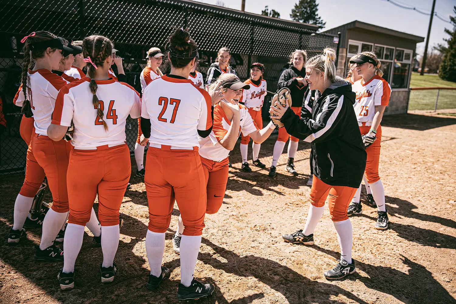 Coach celebrating with Wartburg softball players