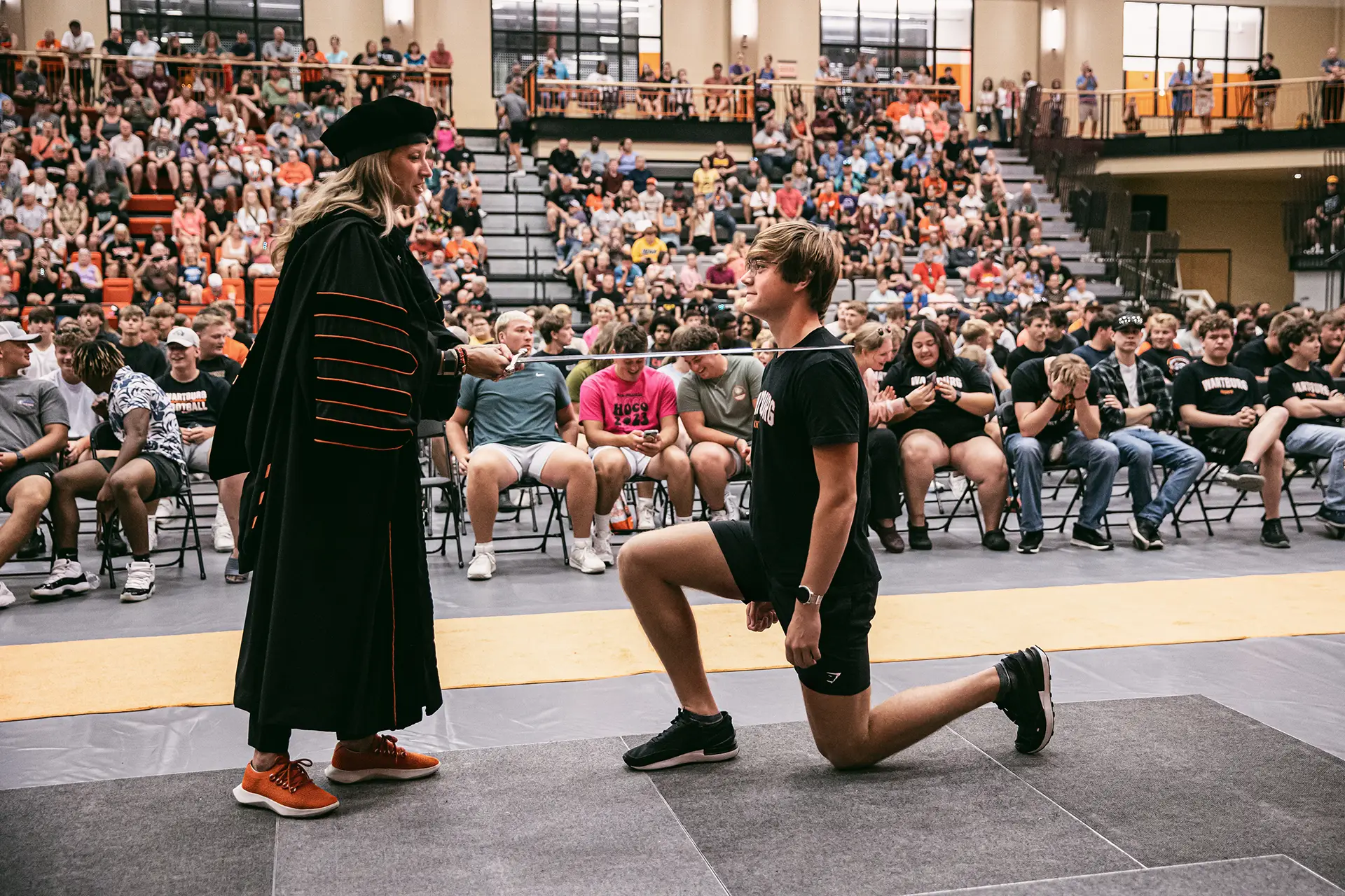 Knighting Ceremony - students being knighted by college president