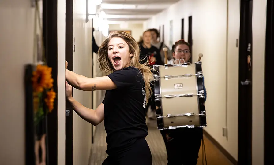  Students storm 
the residence halls on Outfly morning and rally you to the victory bell.