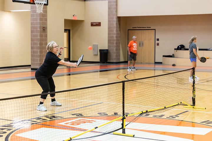 Adults playing pickleball