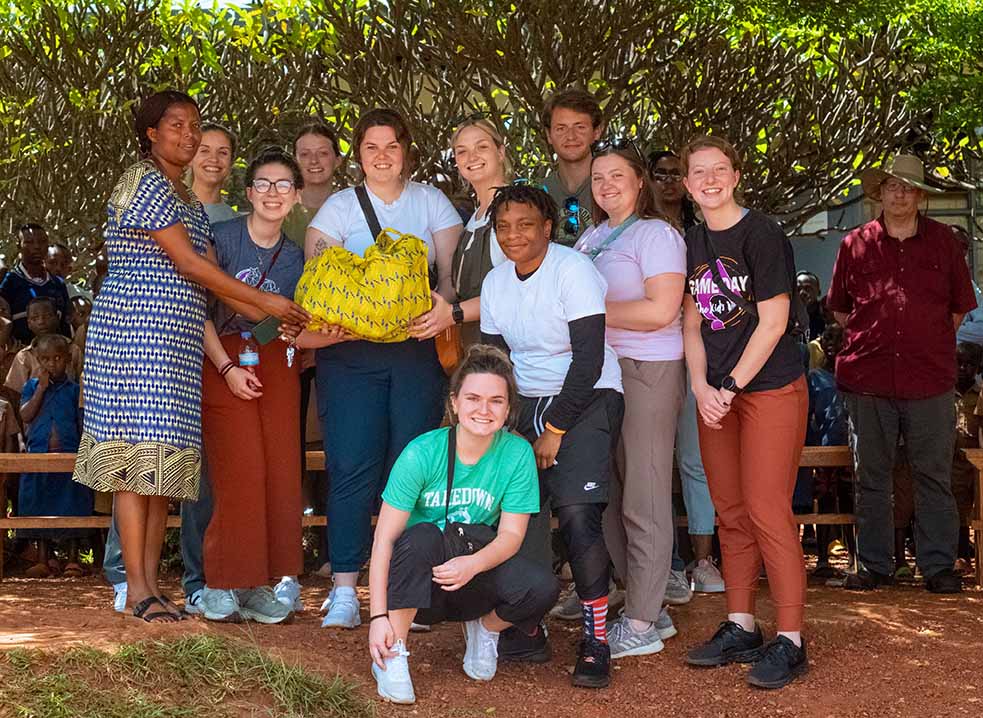 Students and Rwandans pose for a photo together