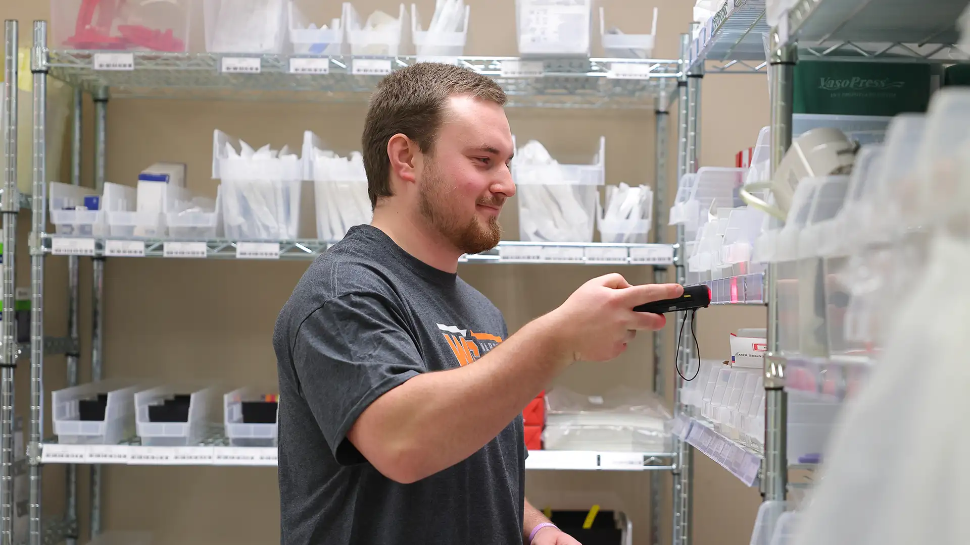 Adam Teare scans items in the Waverly Health Center pharmacy stock room
