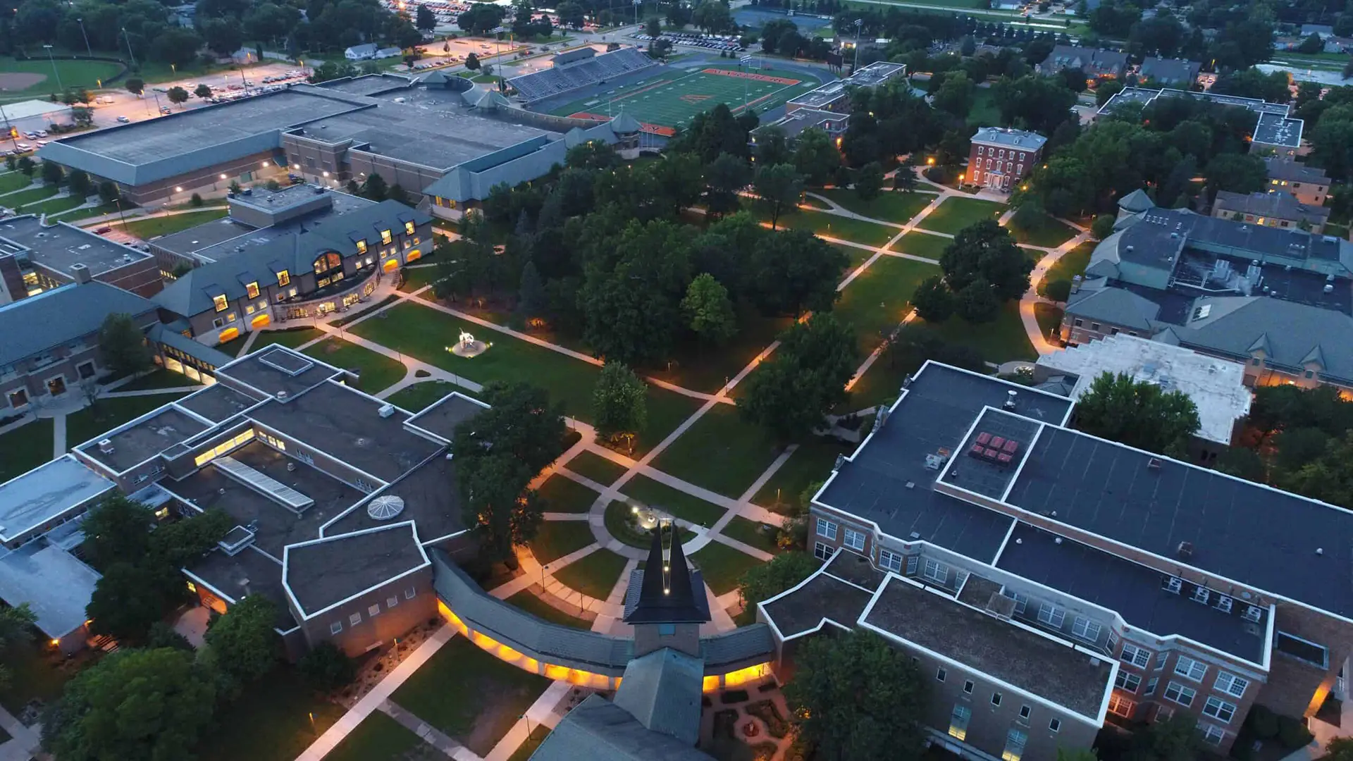 Drone shot of campus lit up at night