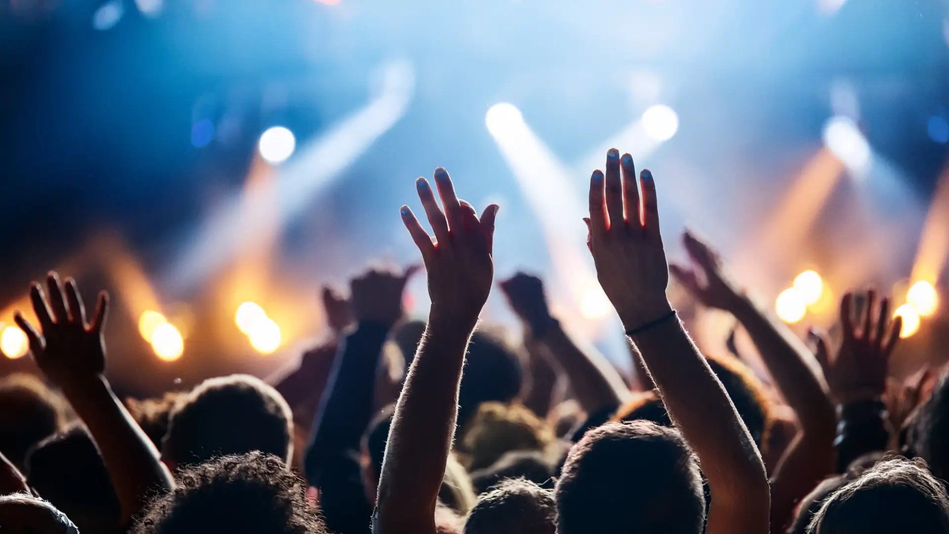 Close up of hands raised at a concert