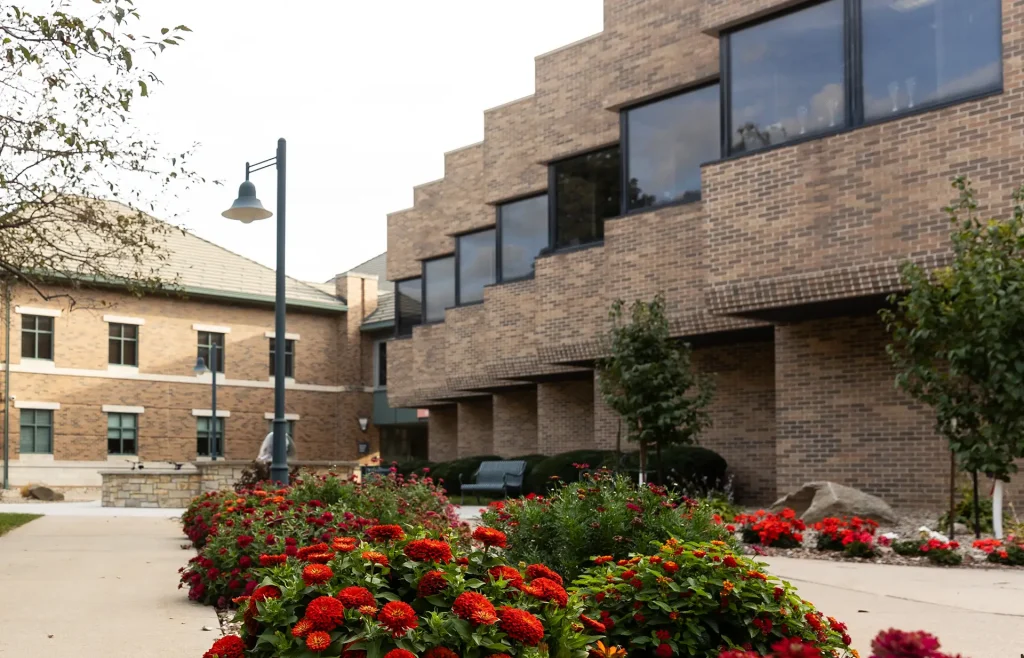 Flower bed in the foreground with Whitehouse Business Center in the background