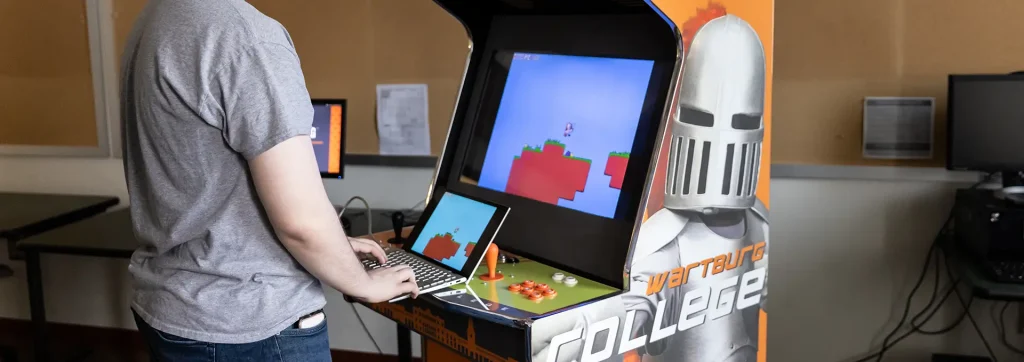Computer science student demonstrating computer game he designed