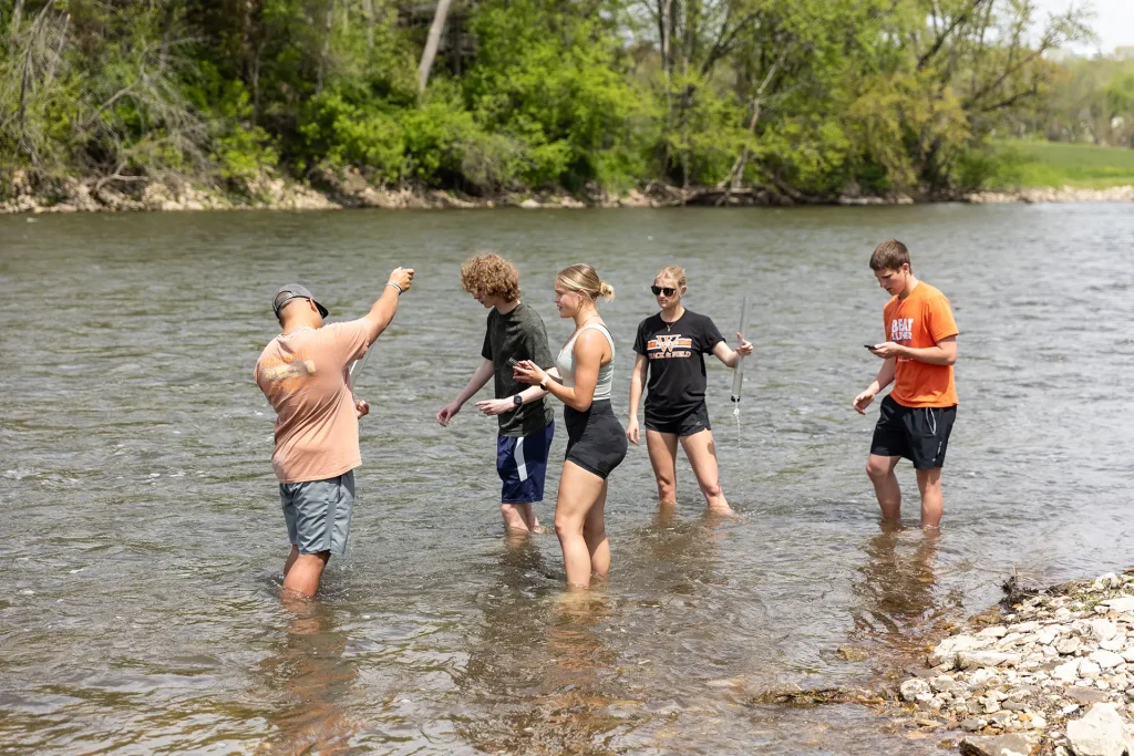 Students in the river conducting research
