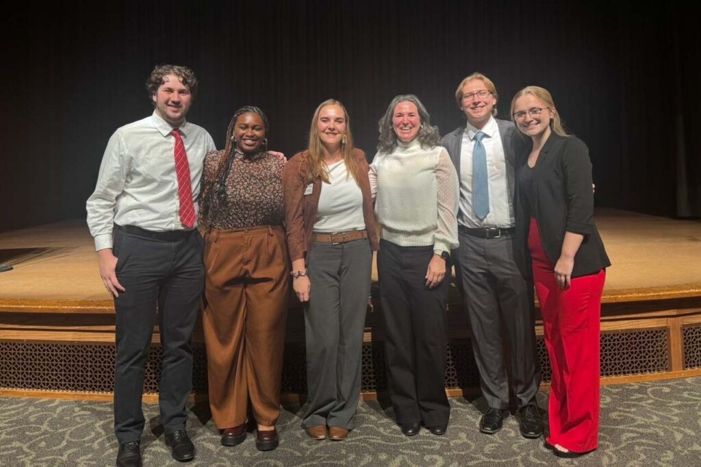 standing left to right are Chris Guerrero, Keziah Ambundo, Hannah Dutcher, Michelle Van Dorn, Caleb Kammerer and Ali Parkhurst