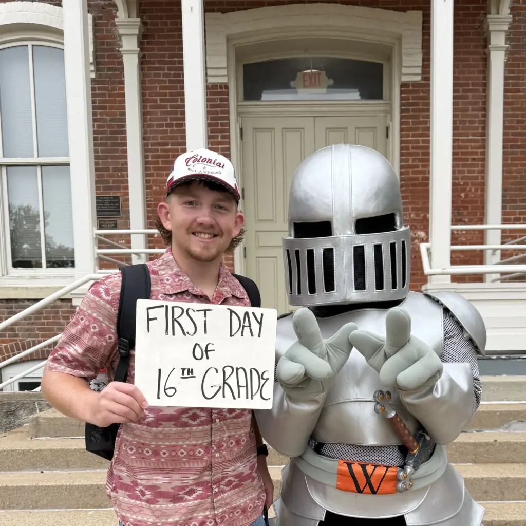 Dawson Clark with Sir Victor holding a sign that says First Day of 16th Grade
