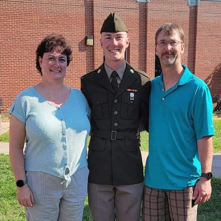 Matthew Tudor in uniform with his parents