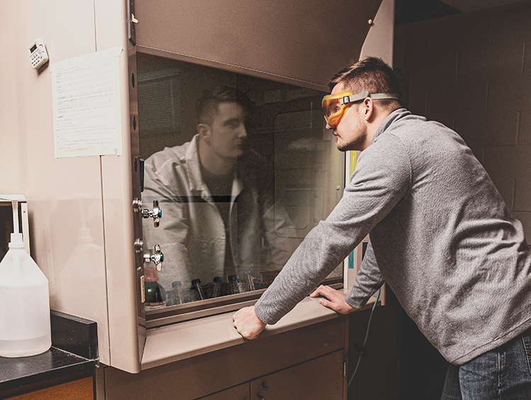 Owen Grover looking at his reflection as a doctor