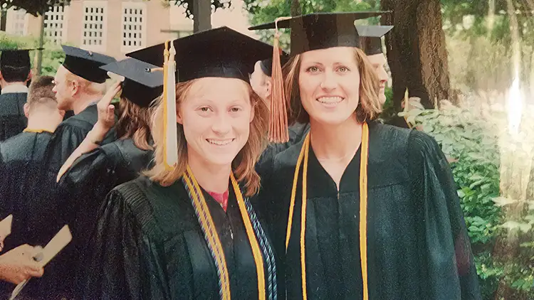 Keri and Jenni at graduation in their gowns