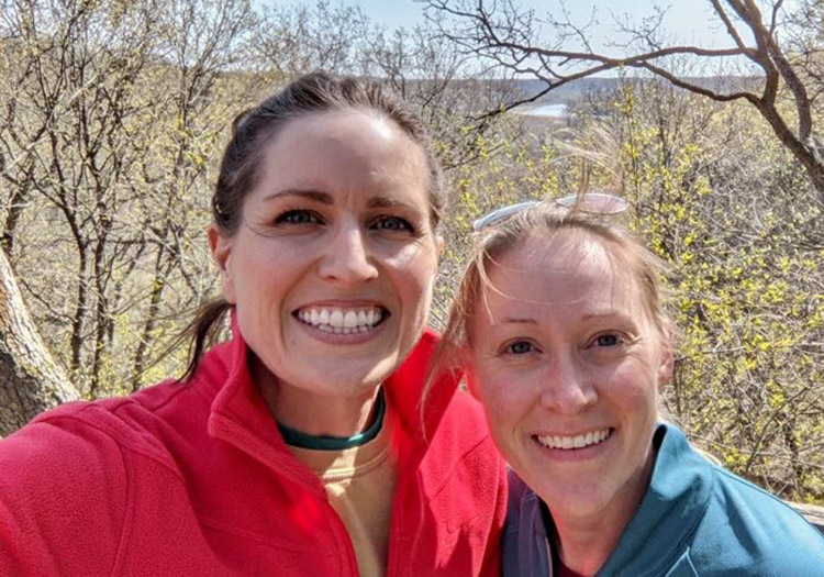 Keri and Jenni on a hike as adults
