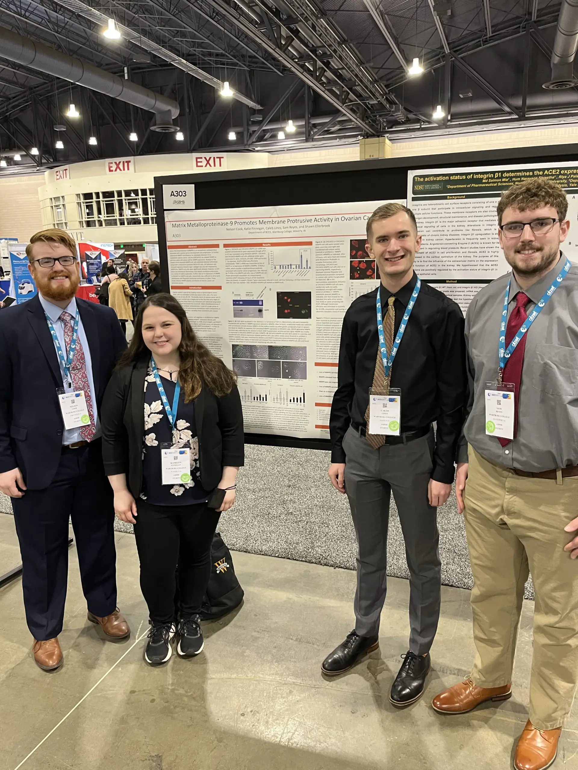 From left Nelson Cook, Katelyn Finnegan Marvin, Caleb Lines, and Sam Reyes stand with their research poster at a conference where they presented.