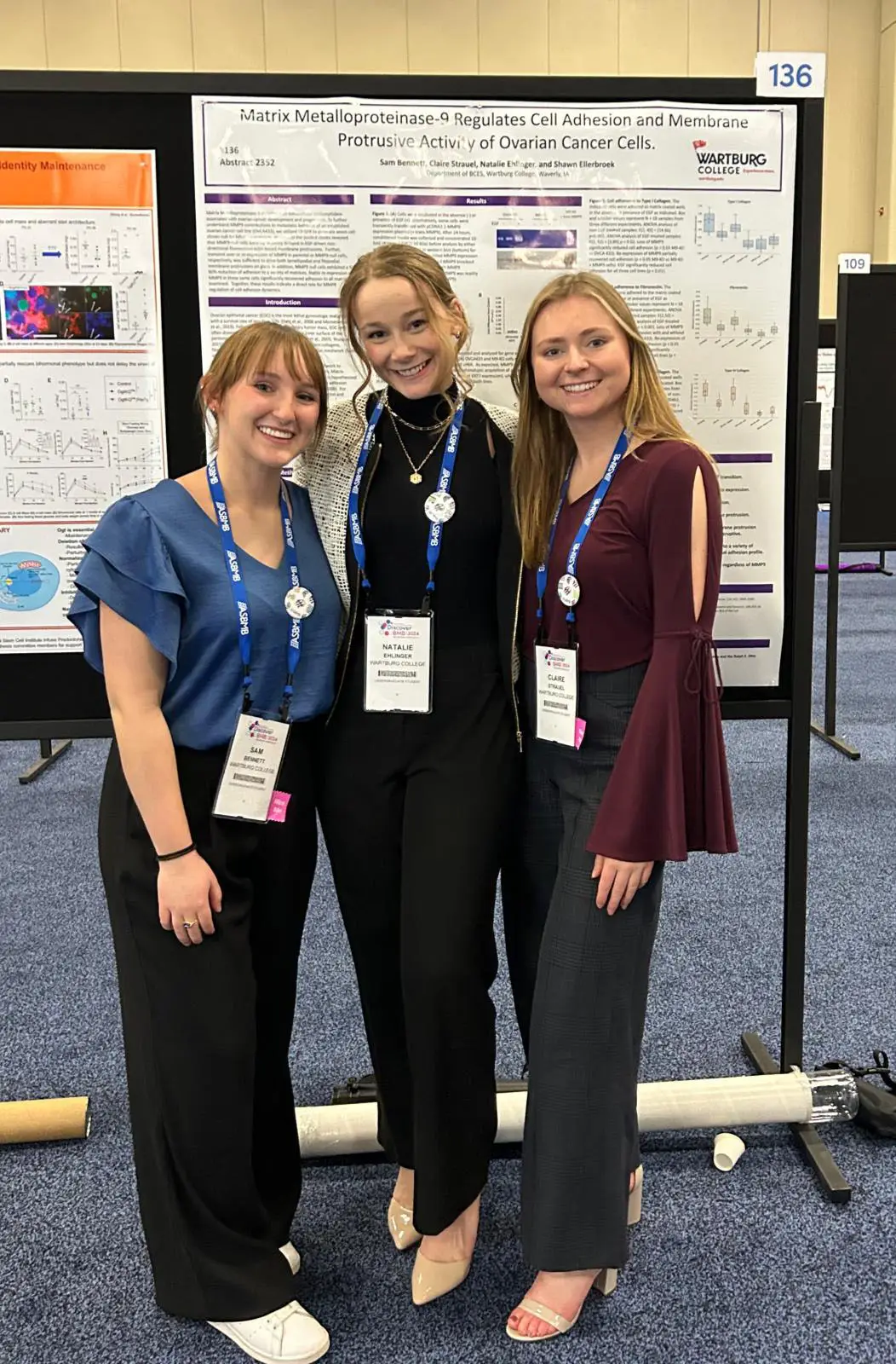 from left Sam Bennett, Natalie Ehlinger, and Claire Strauel stand with the research poster they presented at the American Society for Biochemistry and Molecular Biology annual meeting