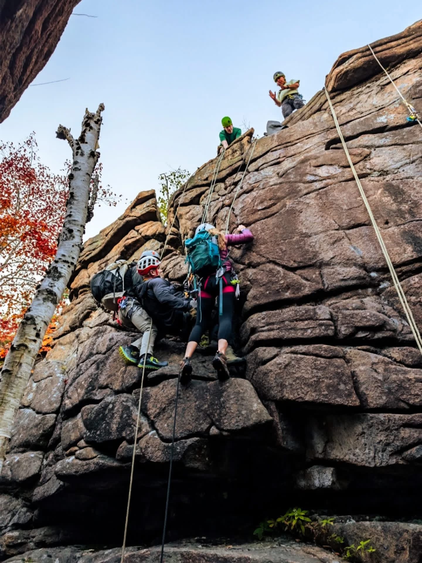 Natalie Bonthius works with students and trainers scaling a mountain safely