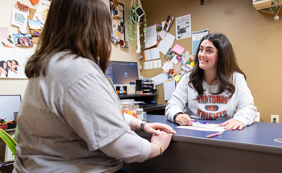 Staff member providing academic support for a student