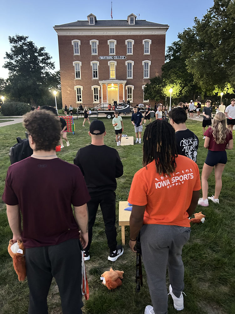 Students on the campus lawn in front of old main doing an activity for Castle Connections