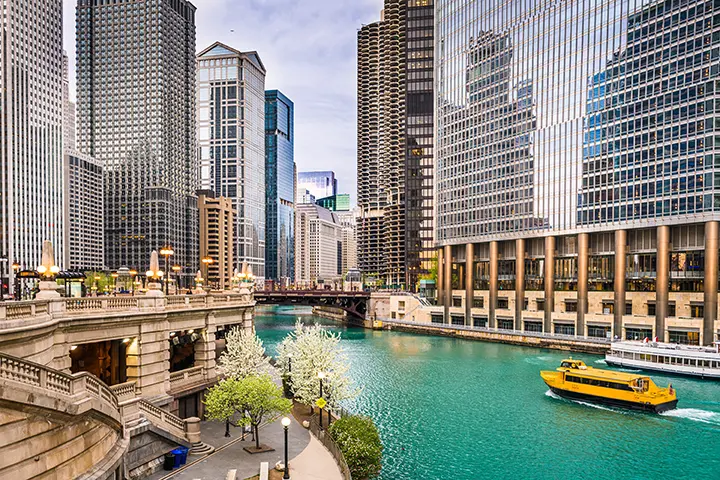 A ferry cruises down the river in downtown Chicago.
