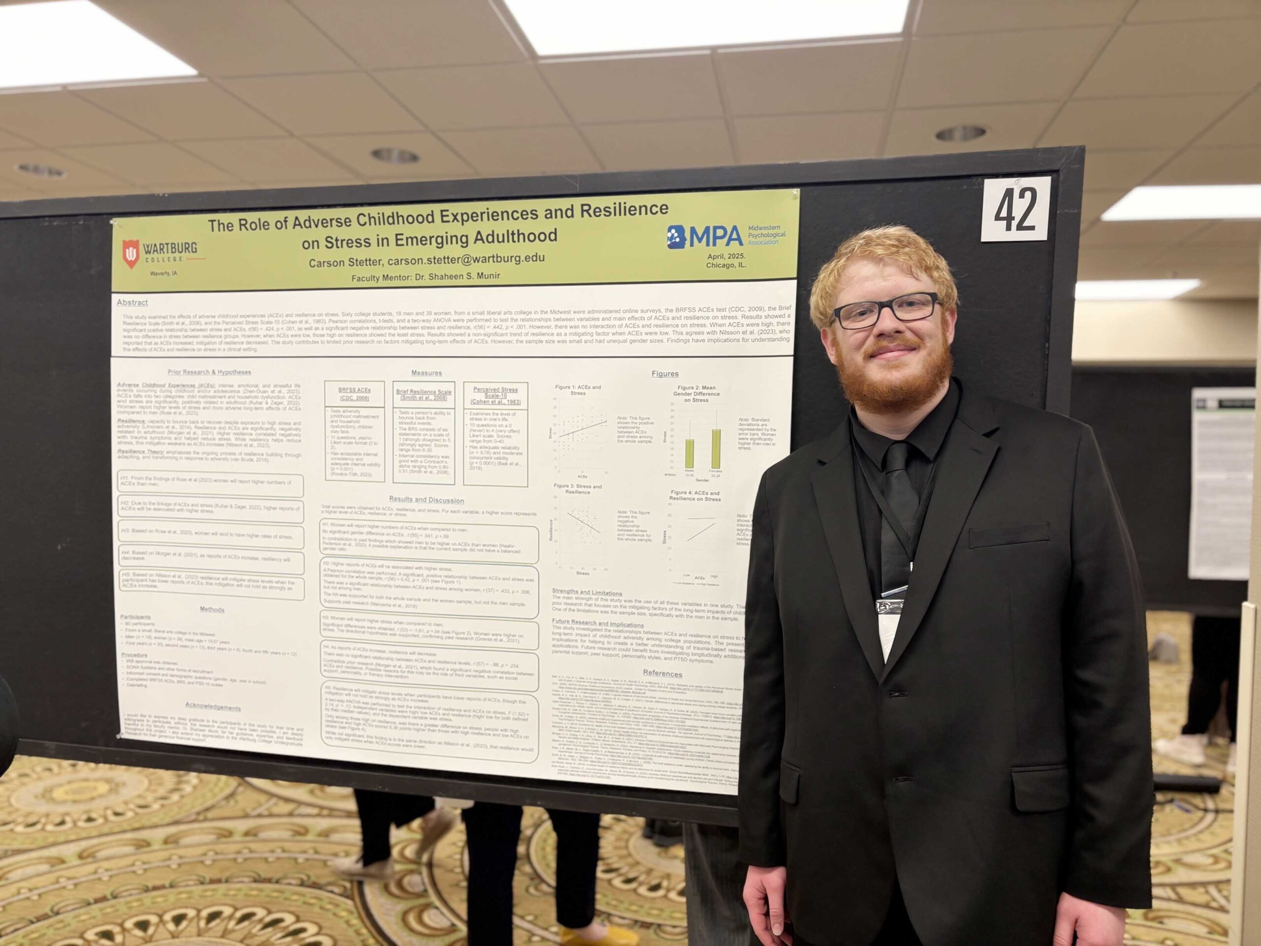 Carson Stetter stands in front of a display board with his research poster at the Midwestern Psychological Association conference.