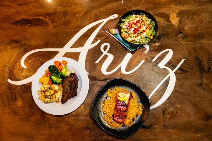Food from Ari'z on a wooden surface with the logo in white.
