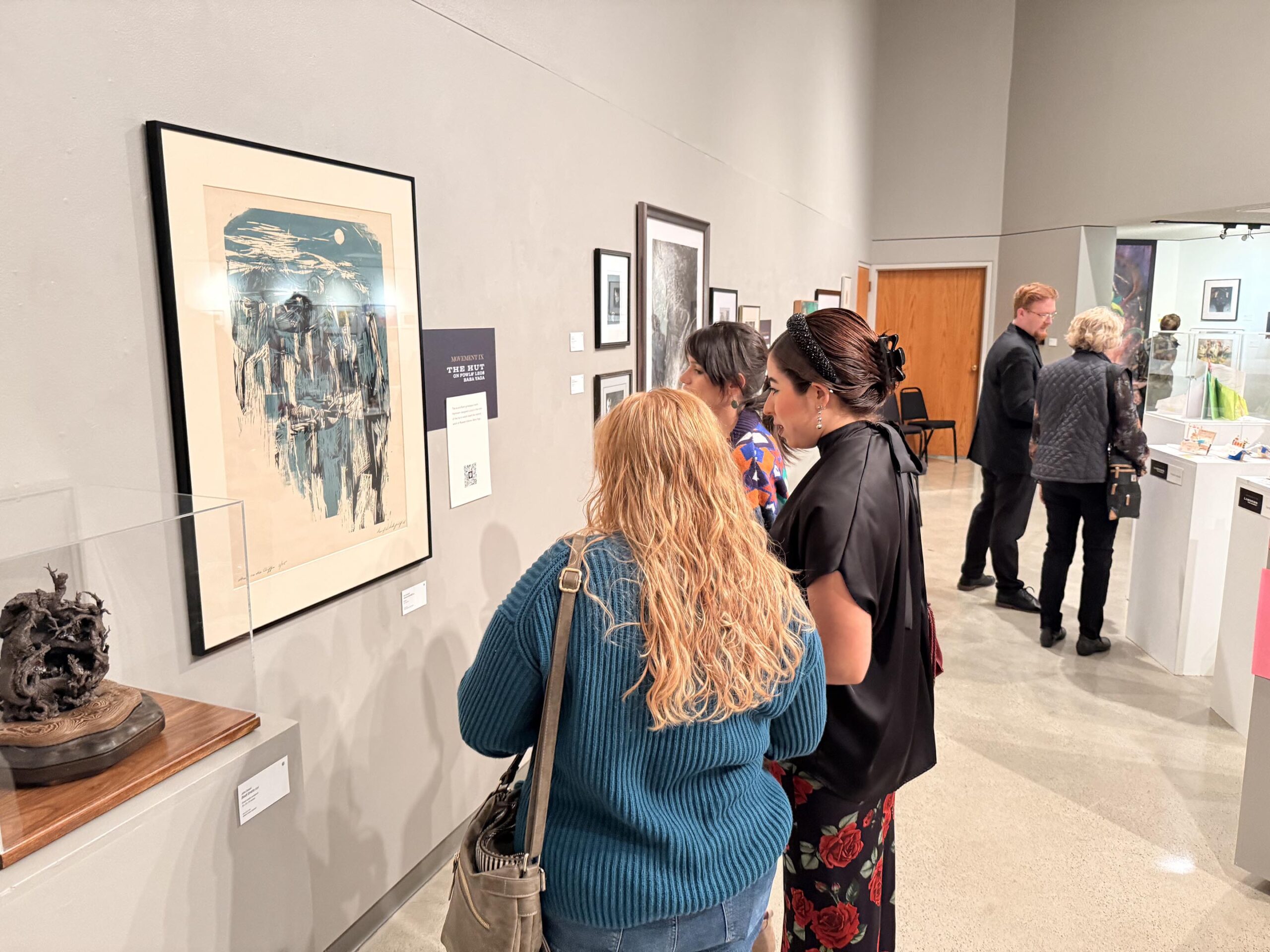 Visitors appreciate art on the walls of the Waldemar A Schmidt Art Gallery on the Wartburg campus